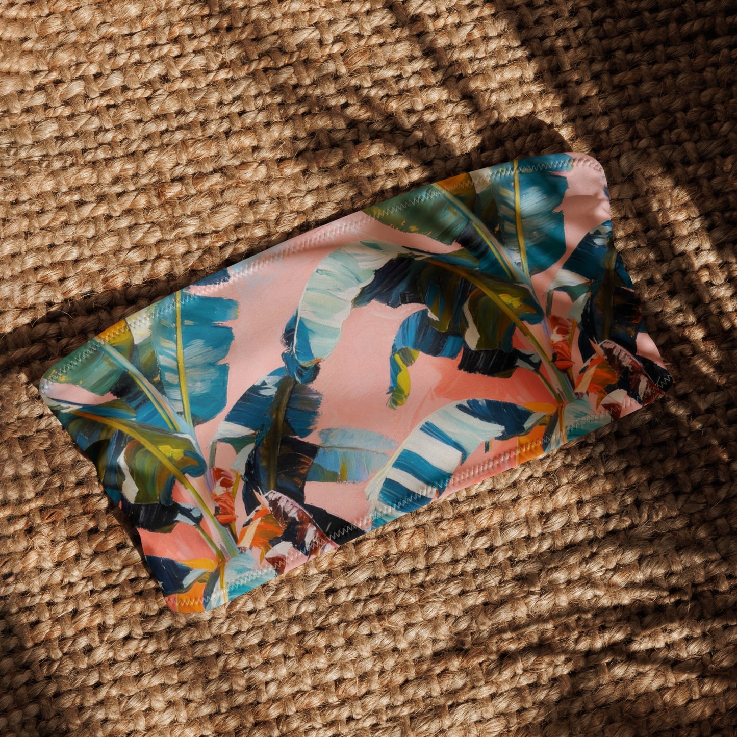 Floral-patterned pouch on a textured woven surface