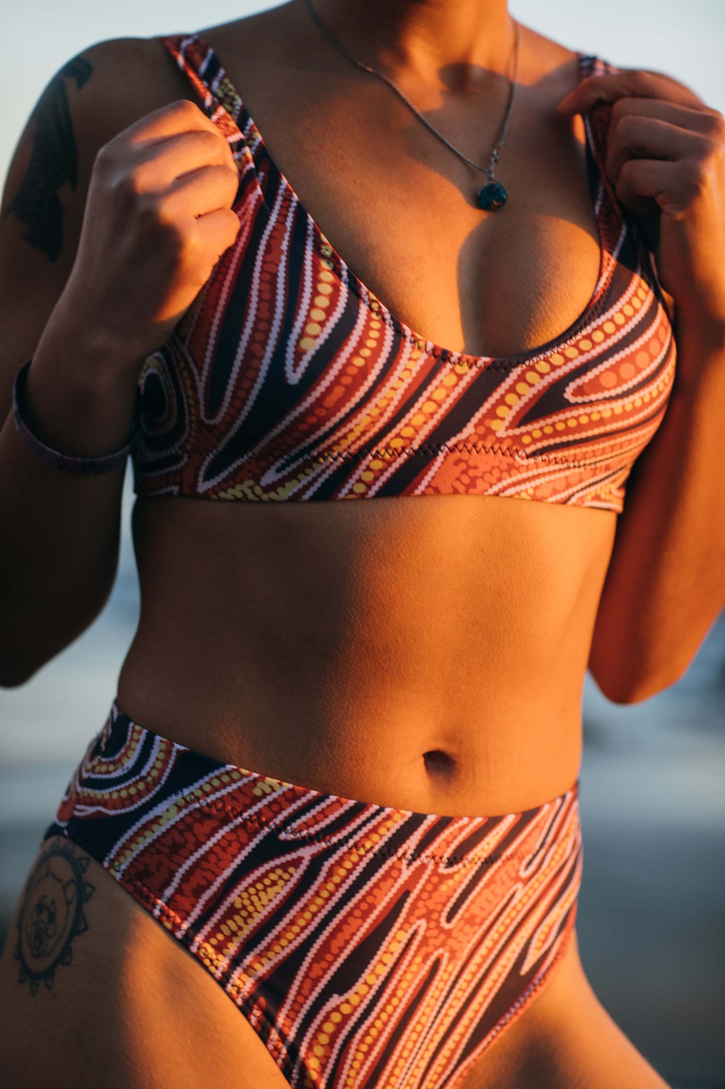 Red earth by Francine Kulitja Padded Sustainable Top - PaletTheory